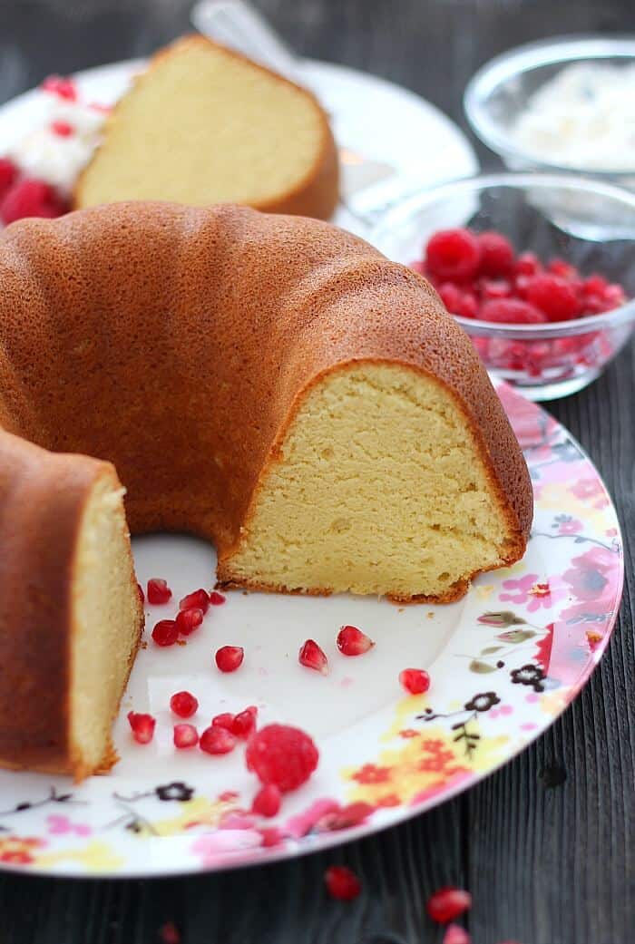 Perfect Pound Cake with one slice missing on a flowered plate