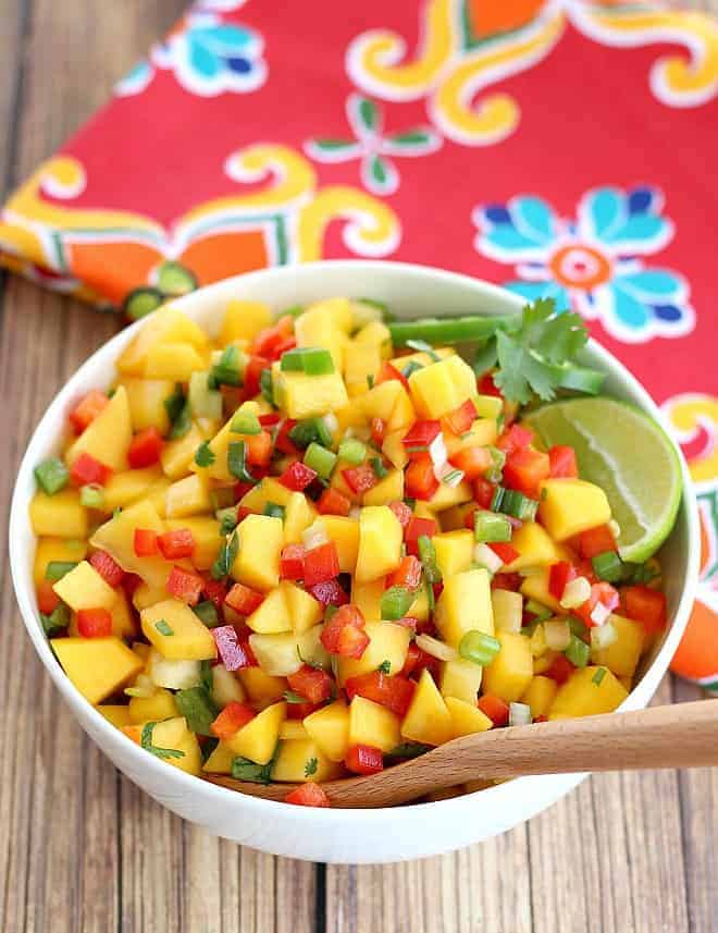 Fresh Mango Salsa served in a white bowl with a lime wedge