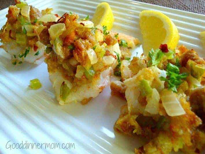 Shrimp with crab stuffing and lemons on a white plate