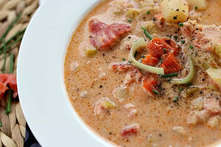 Close up of smoked salmon chowder with potatoes and salmon and leeks.