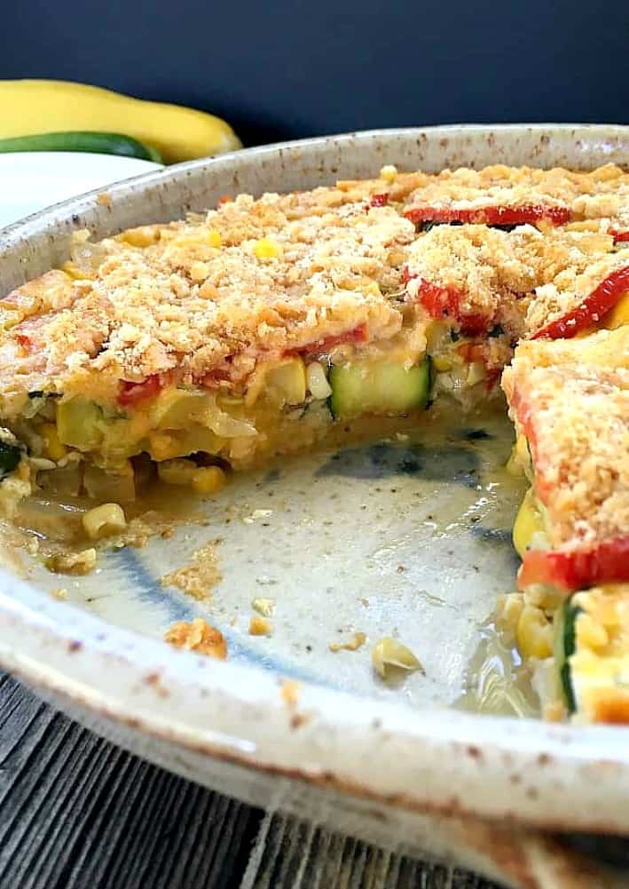zucchini casserole in a baking dish with one slice missing