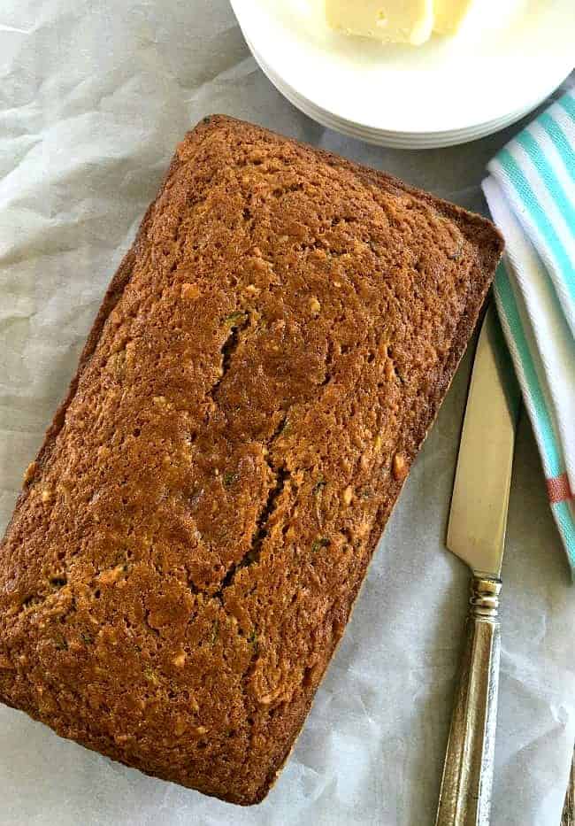 Carrot zucchini bread loaf with butter and butter knife on the side