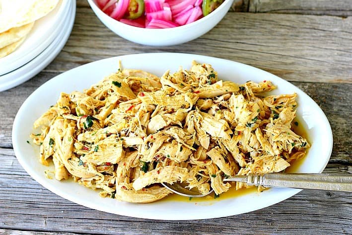 Shredded chicken on a white plate 