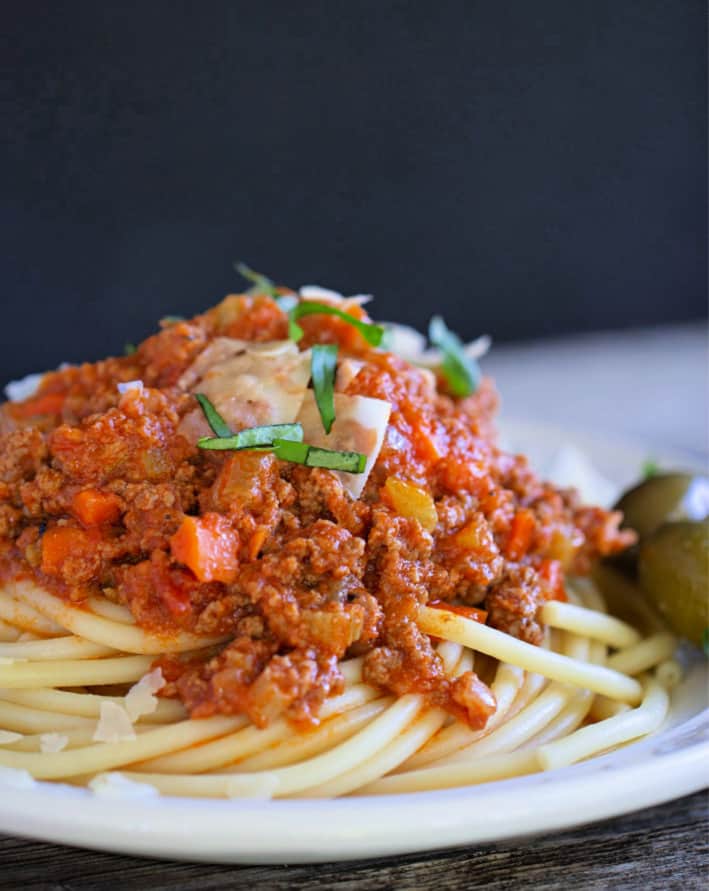 Close up of Bolognese with spaghetti on a white plate