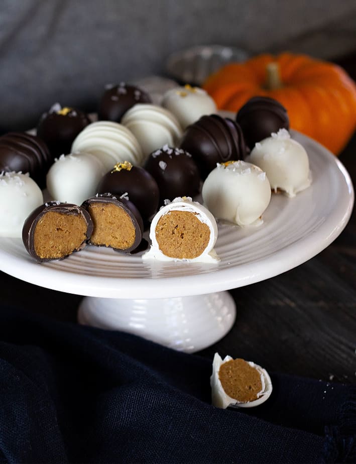 Pumpkin Truffles served on a white severing plater with two cut open