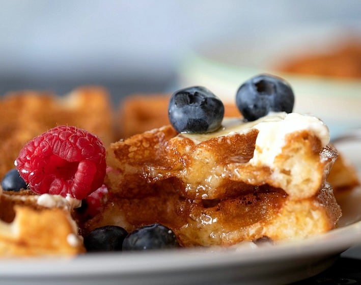 Close up of waffles with berries and syrup