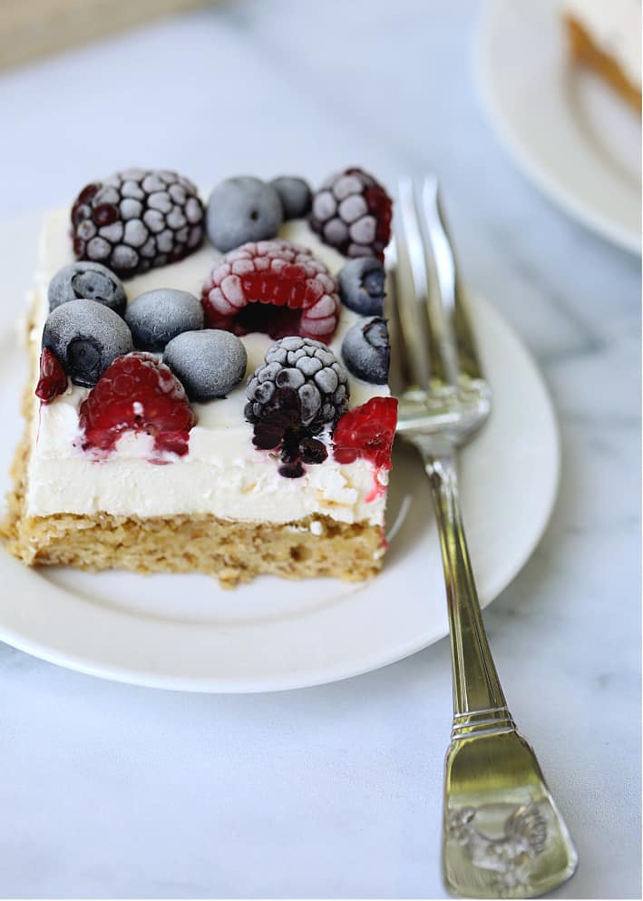 mixed berries and cream bar single slice on plate with a fork