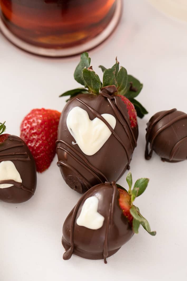 Strawberries dipped in dark chocolate with white chocolate hearts 