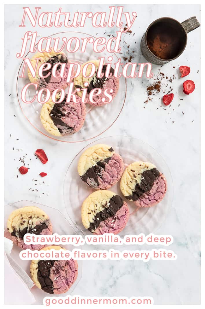 Neapolitan cookies on clear plates with freeze dried strawberries and a tin with cocoa powder