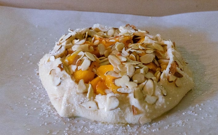 Peach puff pastry tart ready to go into oven.