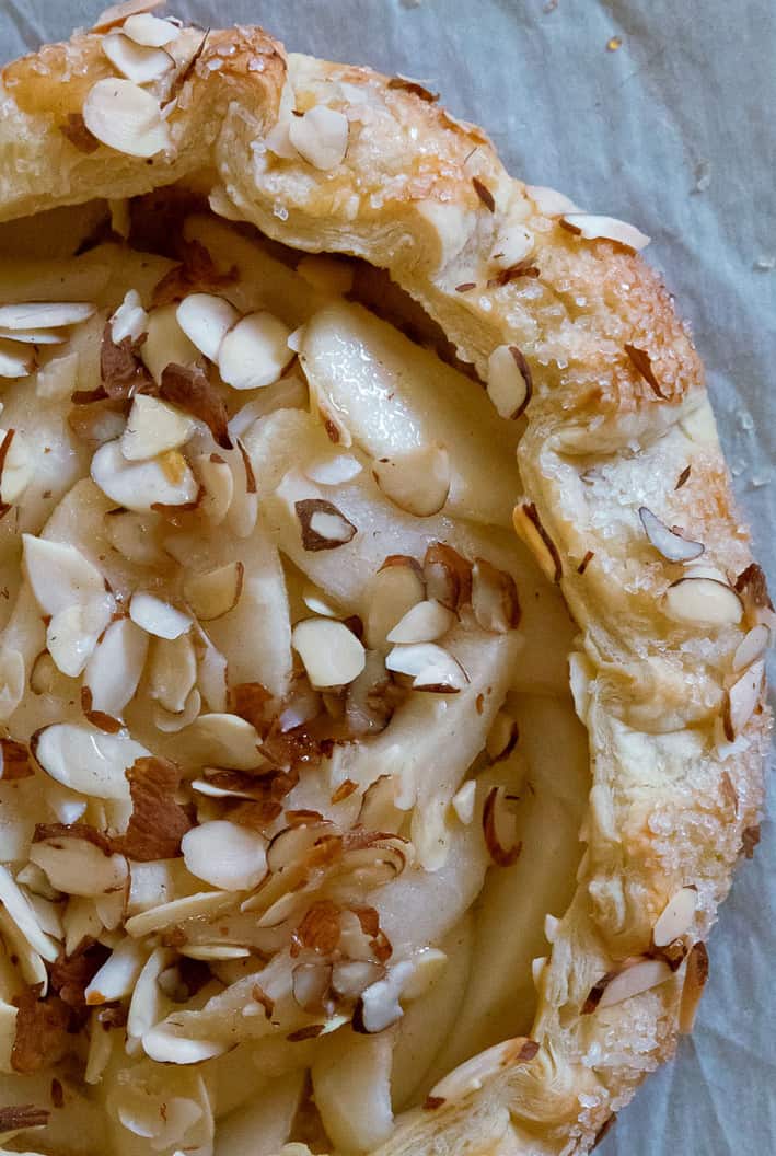 Close up of pear puff pastry tart with sliced almonds