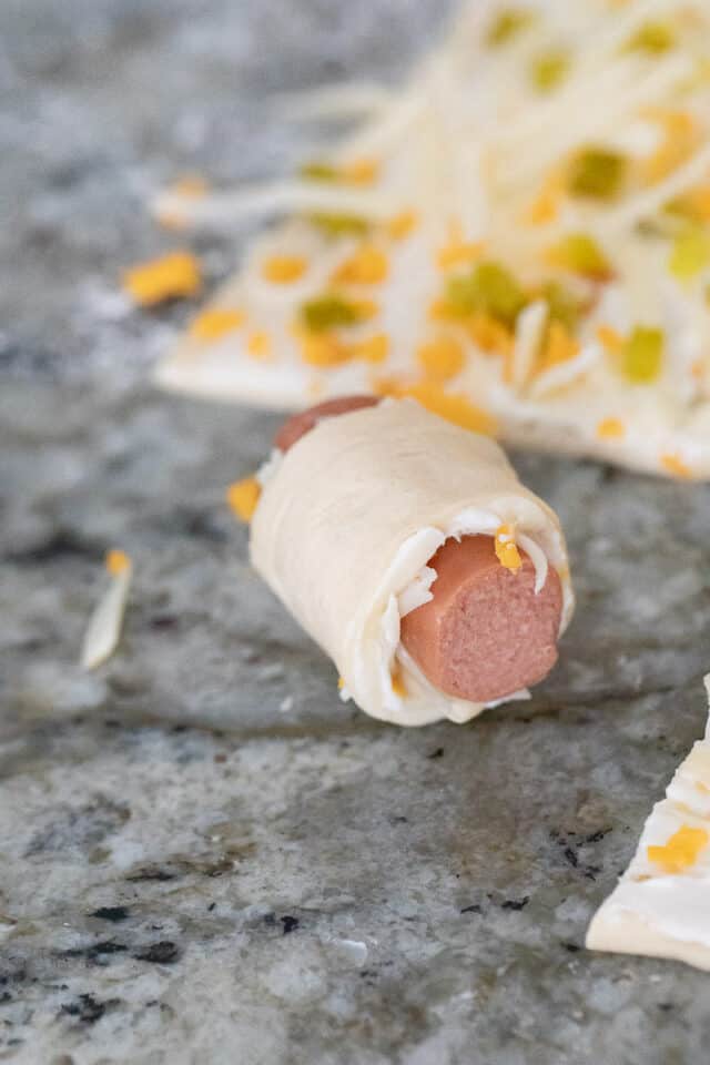 Close up of one jalapeno popper pig in a blanket before baking