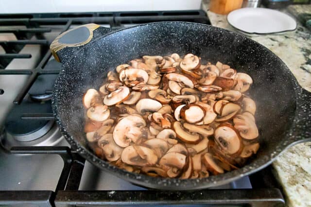 Mushrooms in pan cooking on stove