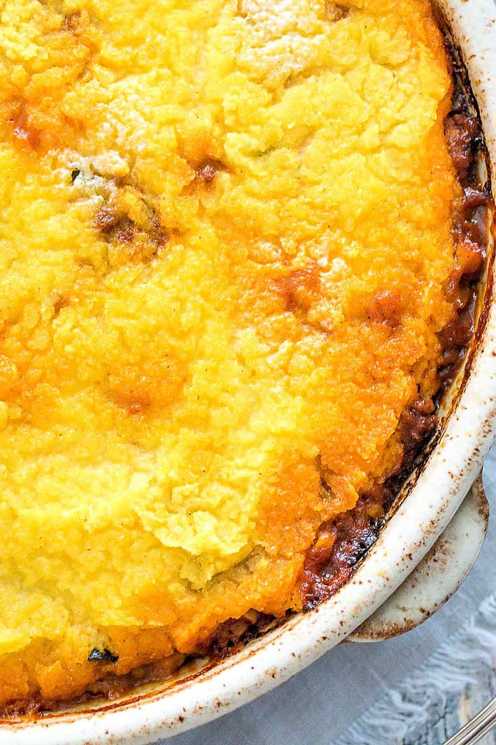 close up of tamale pie after baking. cornmeal crust with sides bubbly