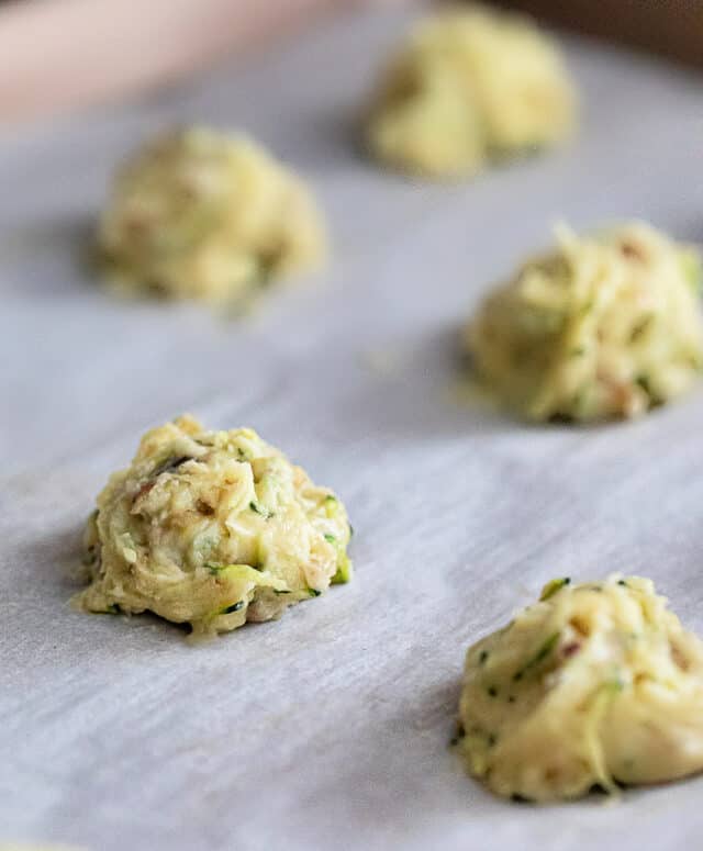 Lemon zucchini cookies prior to baking, on a parchment lined baking sheet