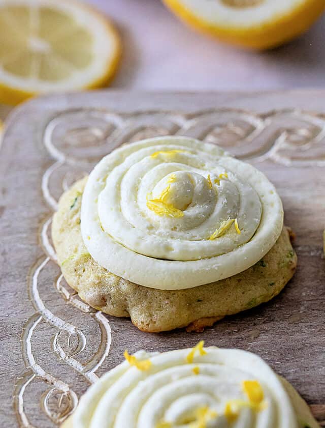 Close up of lemon zucchini cookies with lemon buttercream frosting and lemon zest