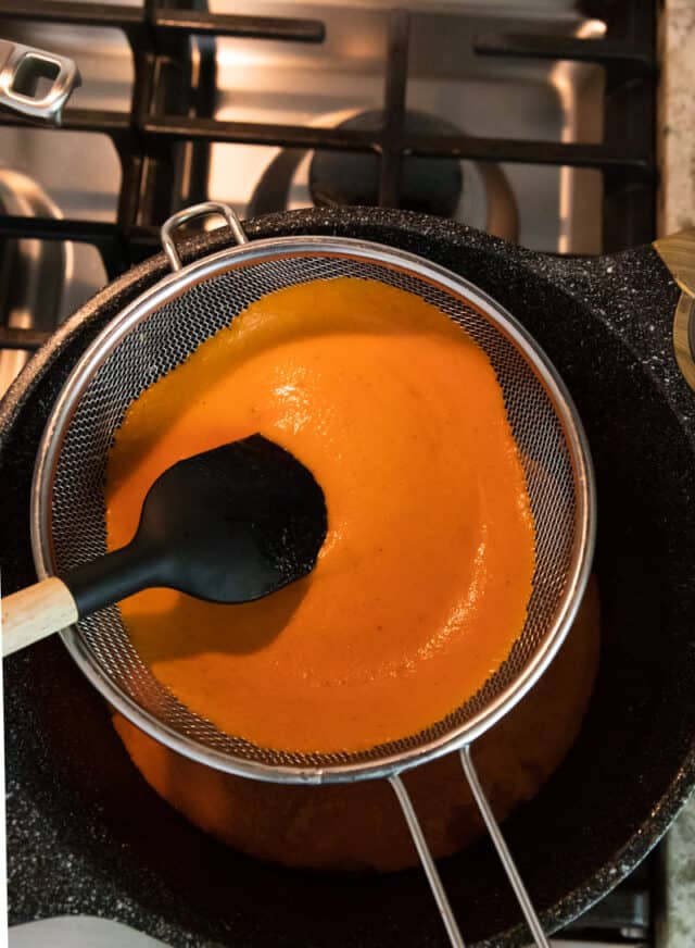 orange tomato bisque after it's been pureed in blender