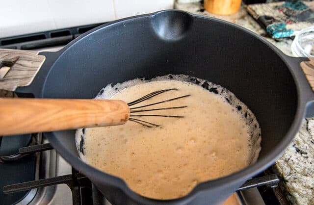 Buttermilk syrup foaming after baking soda is added to pan. Whisk in pan.