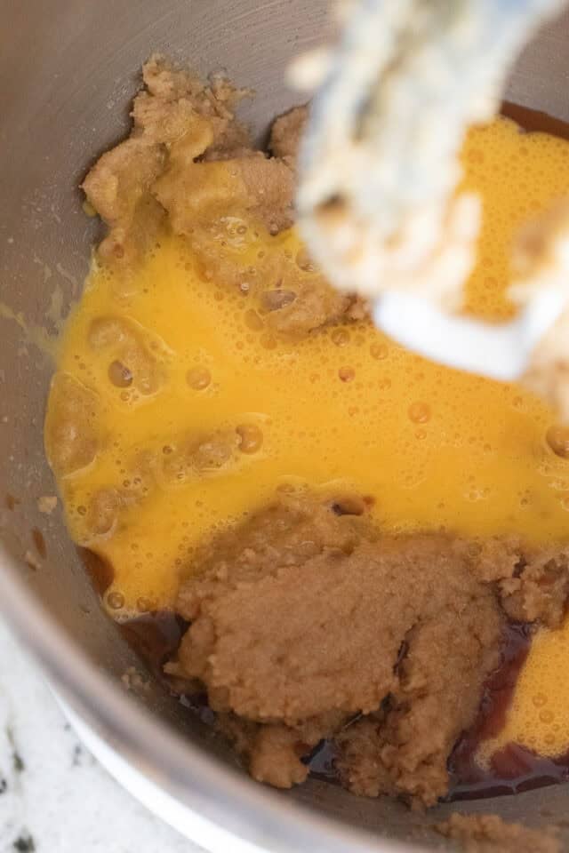 Closeup of batter after whisked eggs and lemon and vanilla extracts poured in, just before mixing into the sugar butter zest mixture.