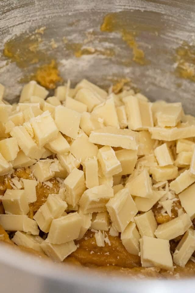 closeup of white chocolate chunks just before mixing into blondie batter.