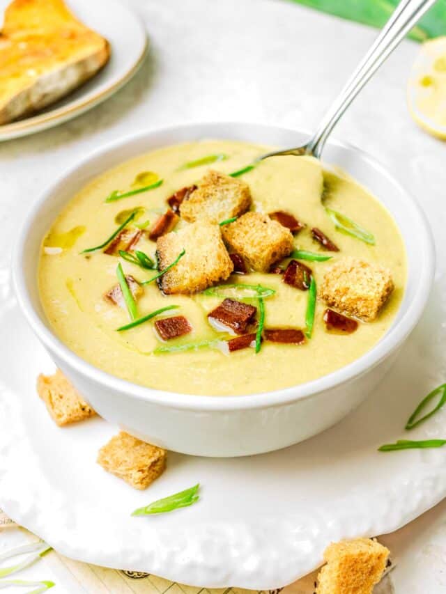 Closeup of Cauliflower Potato Leek Soup with croutons on top.