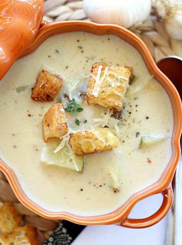 Roasted Garlic Soup with croutons on top.