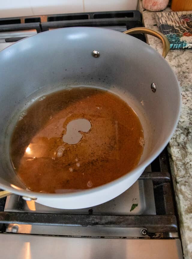 Vinegars, salt, sugar, pepper, garlic powder in a sauce pot after being cooked and reduced.