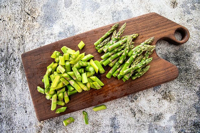 cut up asparagus on cutting board.