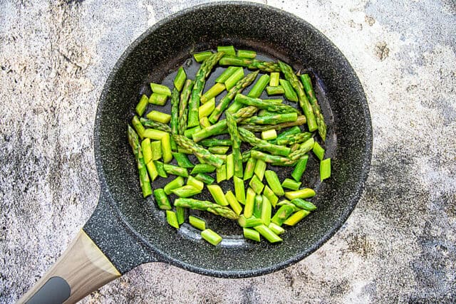 Asparagus cooking in pan.