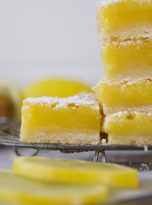 Easy classic lemon bars stacked with single bar on side.