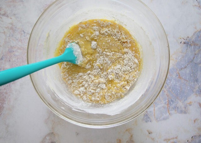 Wet and dry ingredients being folded together for lemon loaf.