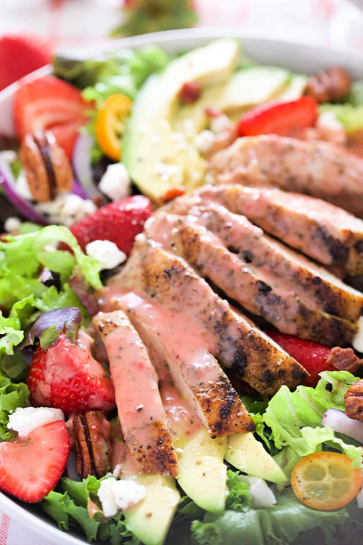 Strawberry chicken salad with strawberry basil vinaigrette poured over chicken.