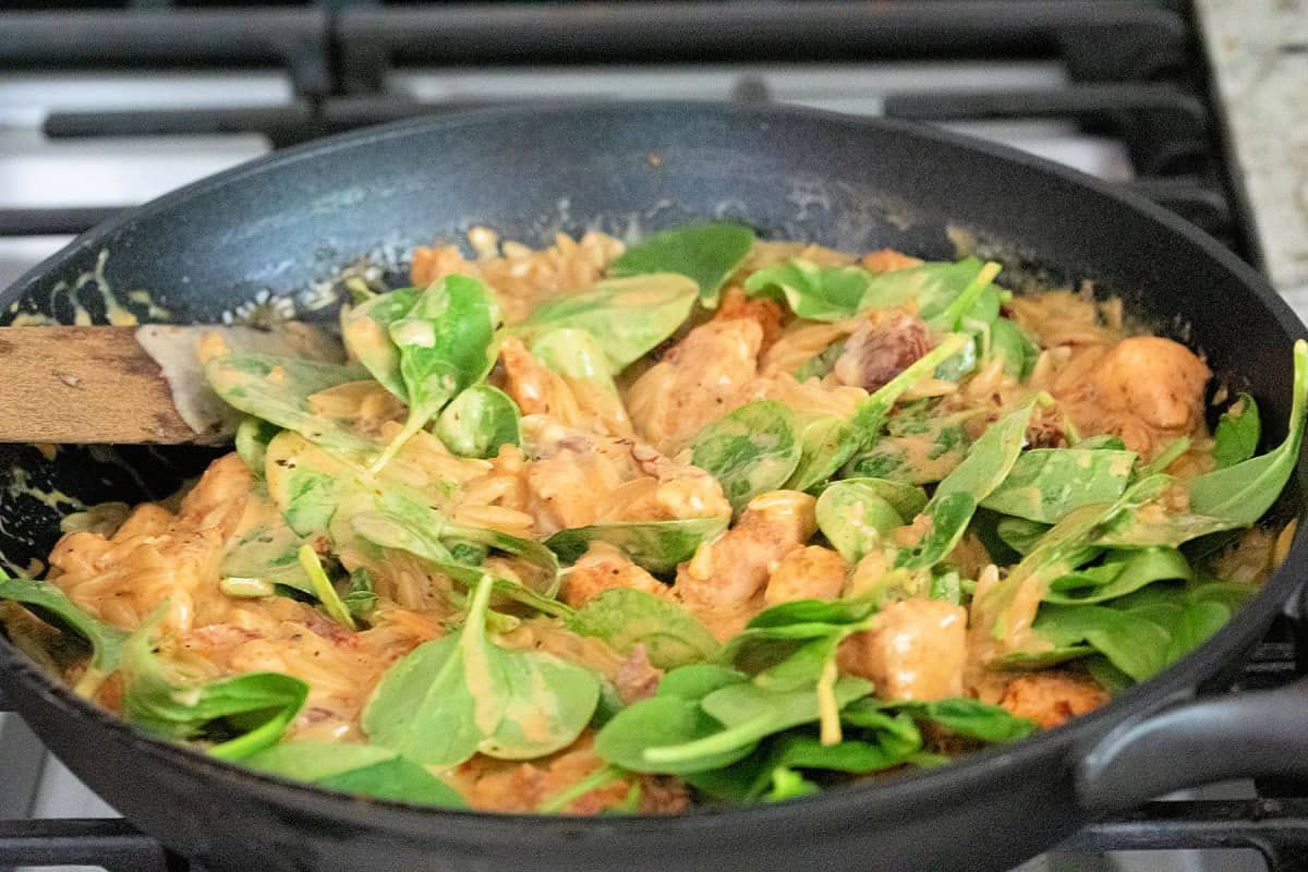 Dish with chicken stirred back in, spinach added to wilt and finish cooking chicken.
