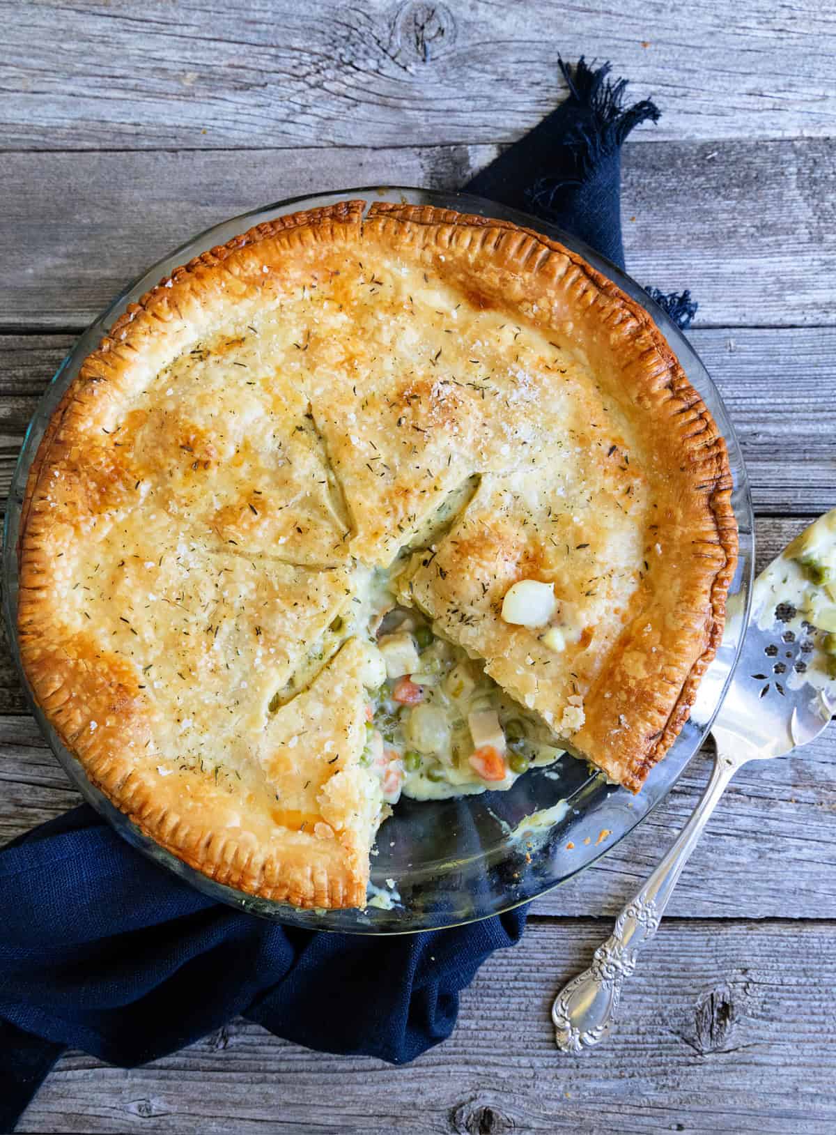 Chicken pot pie with piece cut out of it.