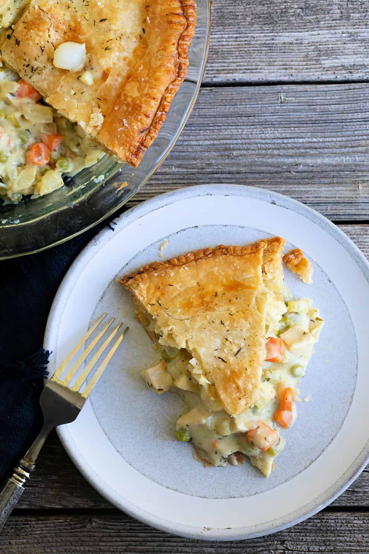 Slice of chicken pot pie and the full pie.