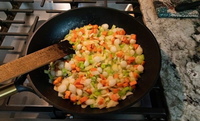 Vegetables sauteeing in pan.