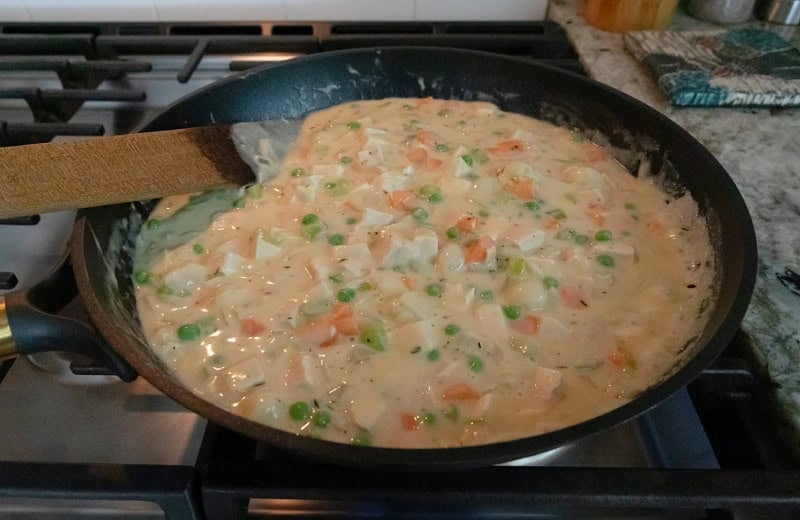 Chicken pot pie filling on the stove.