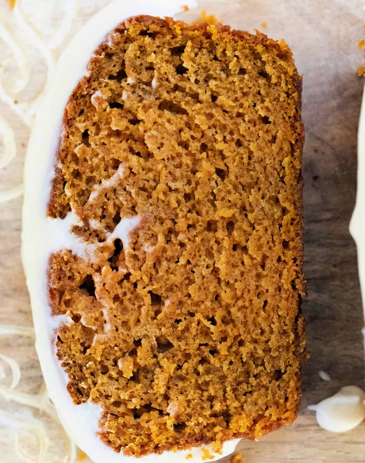 Closeup slice of Pumpkin Bread with Cream Cheese Frosting.