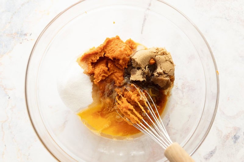 Wet ingredients getting ready to mix: Clockwise, pumpkin, brown sugar, vanilla, eggs, oil, granulated sugar.