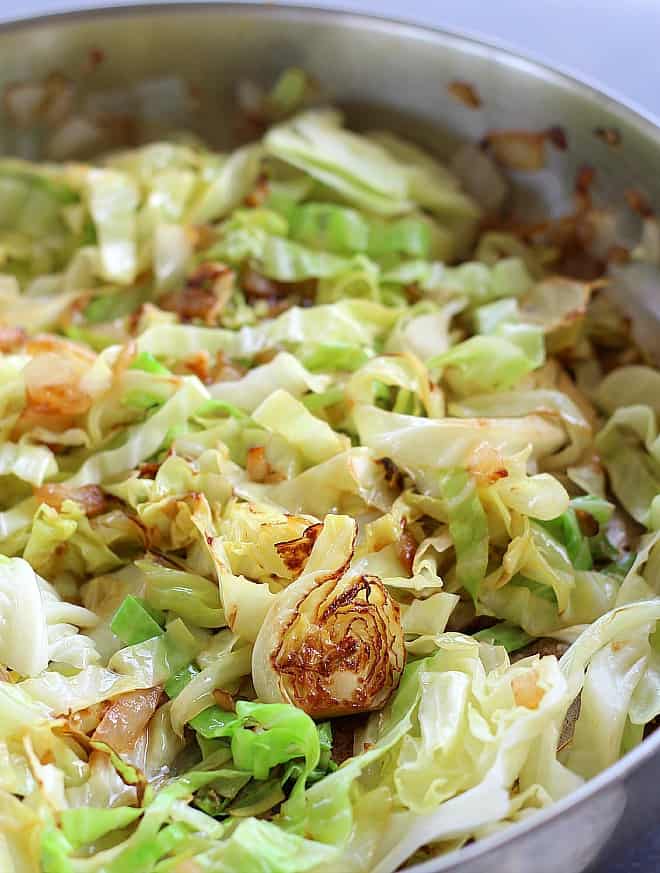 Cabbage sauteed in pan.