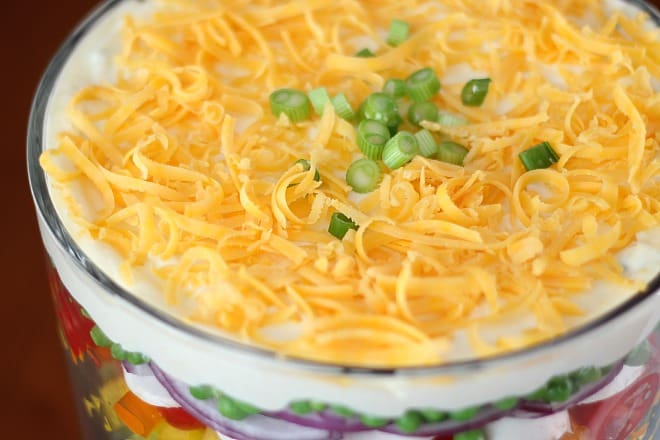 Top view of Layered Salad with cheddar cheese and green onions