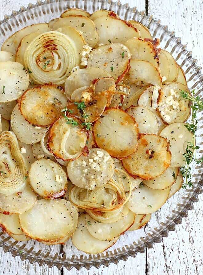 Up Side Down Potato and Onion Tart served on a clear plate
