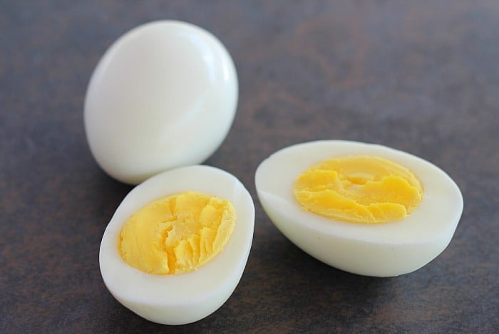 Two Perfect Hard Boiled Eggs one cut open