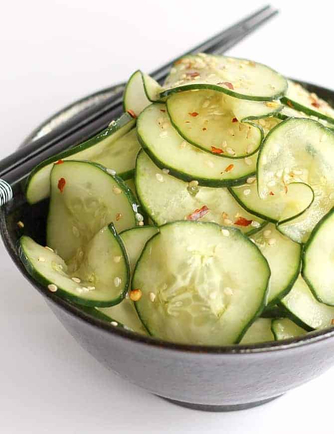 Cucumber Sesame Salad in black bowl and chopsticks