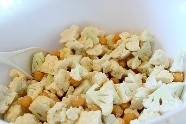 Cauliflower and chickpeas in white bowl before cooked 