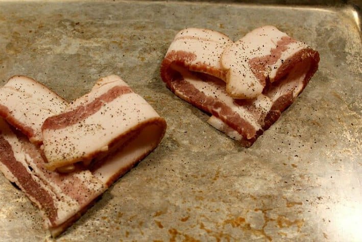  Heart-shaped bacon before baking on baking sheet