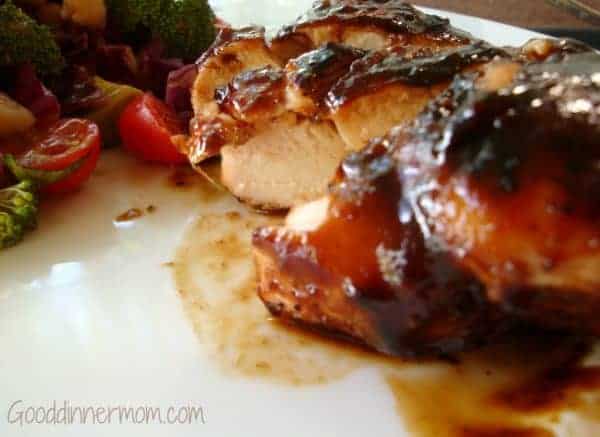 Cut up balsamic chicken with salad 