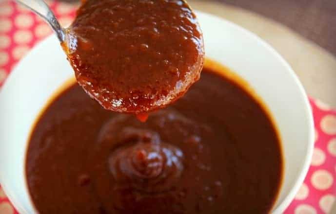  Barbecue sauce in a white bowl with a spoon