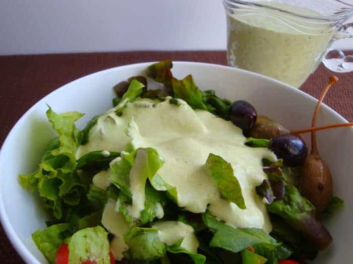 Basil Green Goddess Dressing on salad in white bowl