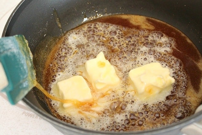 Butter added to browned sugar for homemade caramel sauce